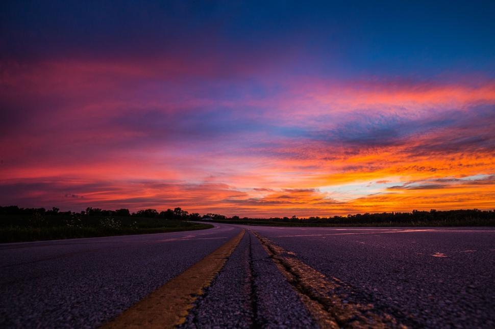 Free Image of Long Stretch of Road With Sunset in Background 