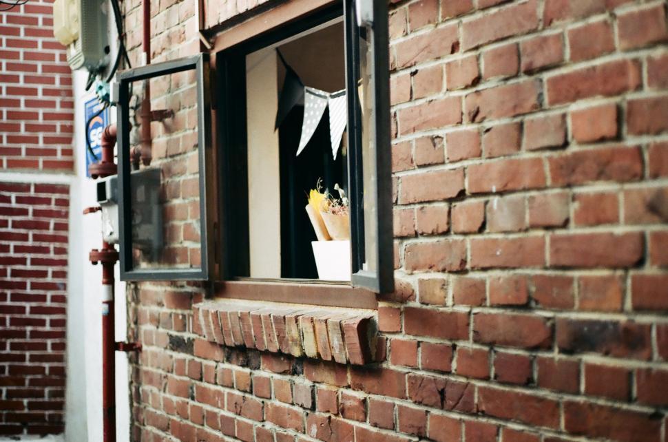 Free Image of Brick Building With Window and Sign 