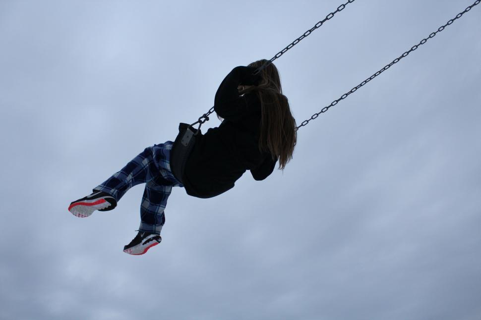 Free Image of Person Hanging From Rope on Cloudy Day 