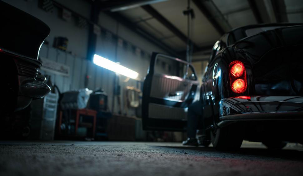 Free Image of Two Cars Parked in a Garage 