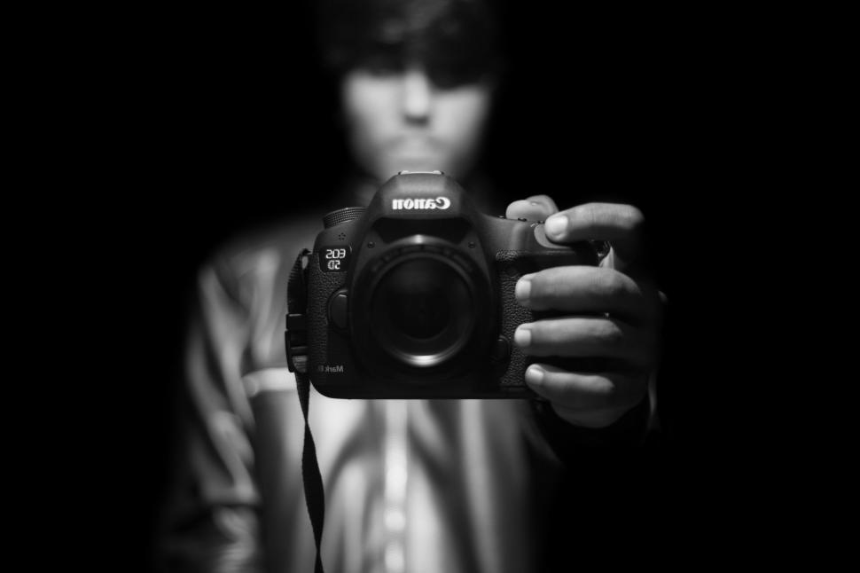 Free Image of Man Holding Camera in Front of Face 
