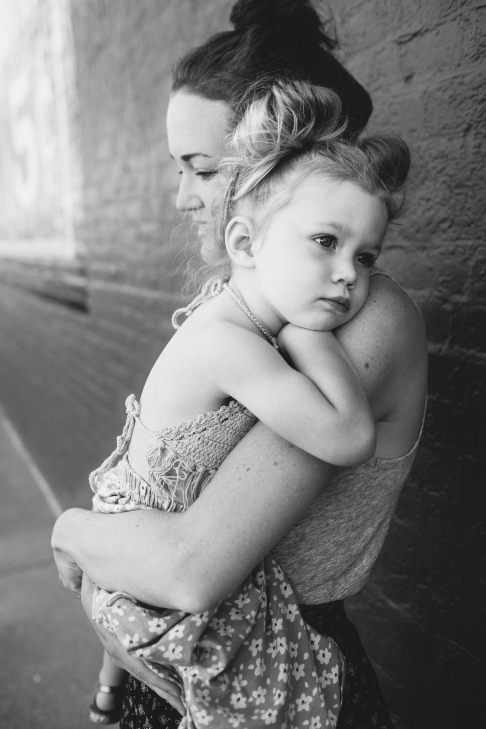 Free Image of Woman Holding Little Girl in Her Arms 