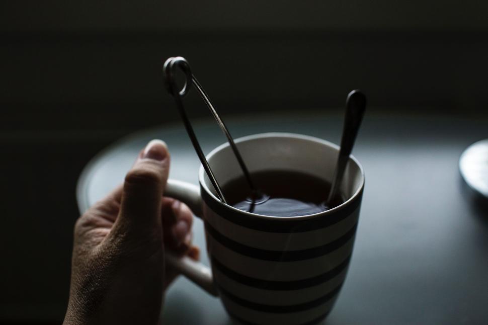 Free Image of Person Holding Coffee Cup With Spoons 