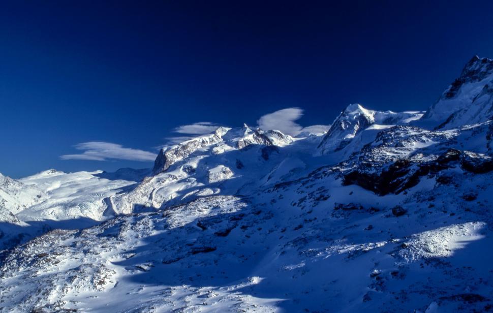 Free Image of Snow-Covered Mountain Under Blue Sky 
