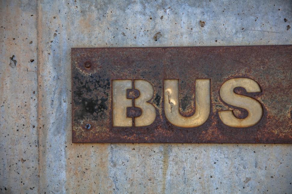 Free Image of Rusted Bus Sign on Concrete Wall 