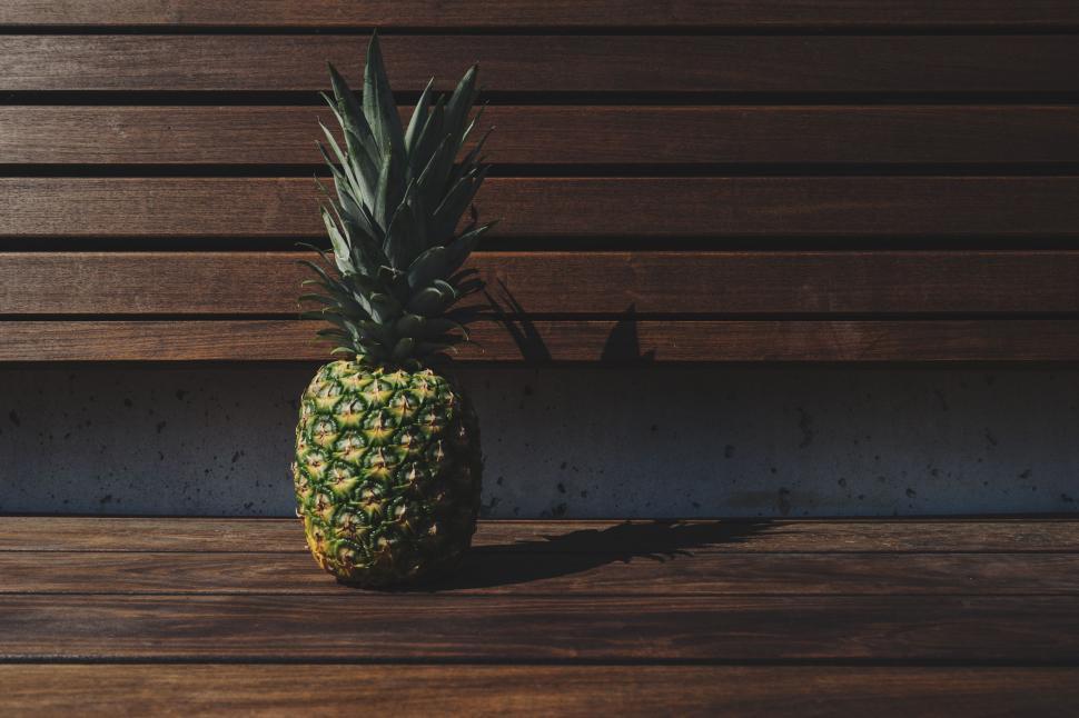 Free Image of Pineapple on Wooden Bench 