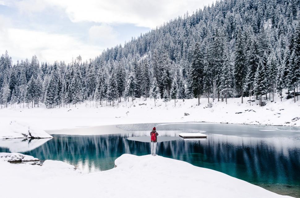 Free Image of Person Standing in Snow by Lake 