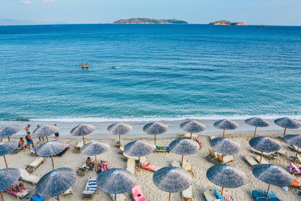 Free Image of Beach Filled With Lawn Chairs and Umbrellas 