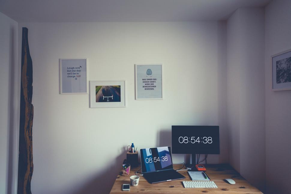 Free Image of Desk With Computer and Clock 
