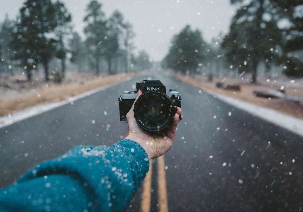 Free Image of Person Taking a Picture of Snowy Road 