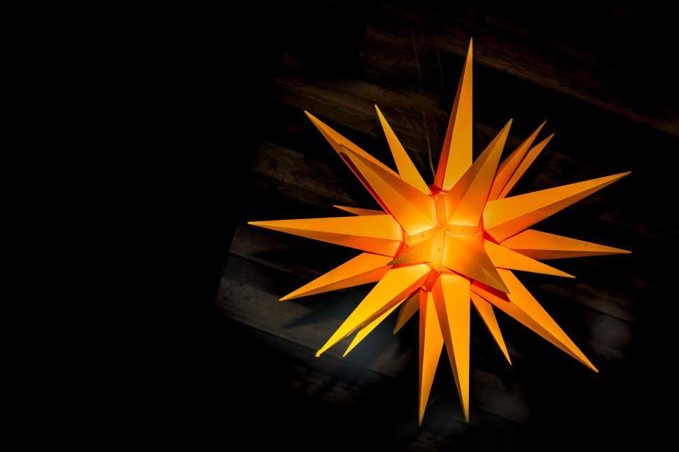 Free Image of Large Orange Star Hanging From Ceiling 