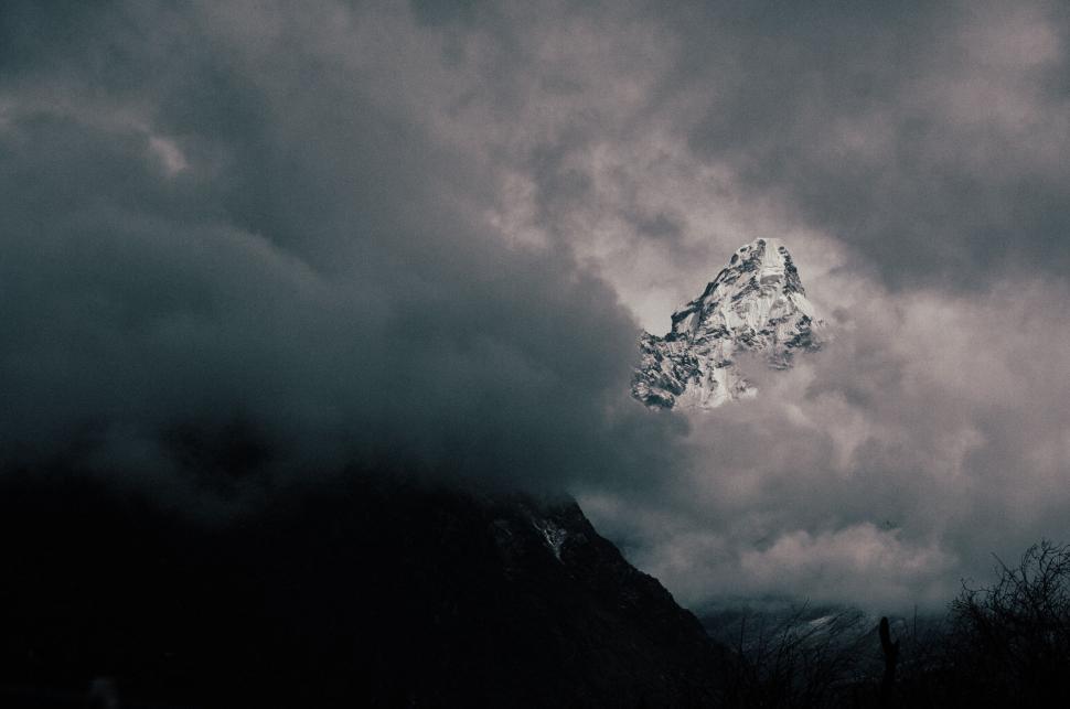 Free Image of Cloudy Sky Over a Distant Mountain 