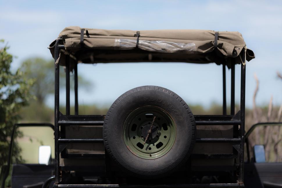 Free Image of Jeep With Flat Tire and Tarp 