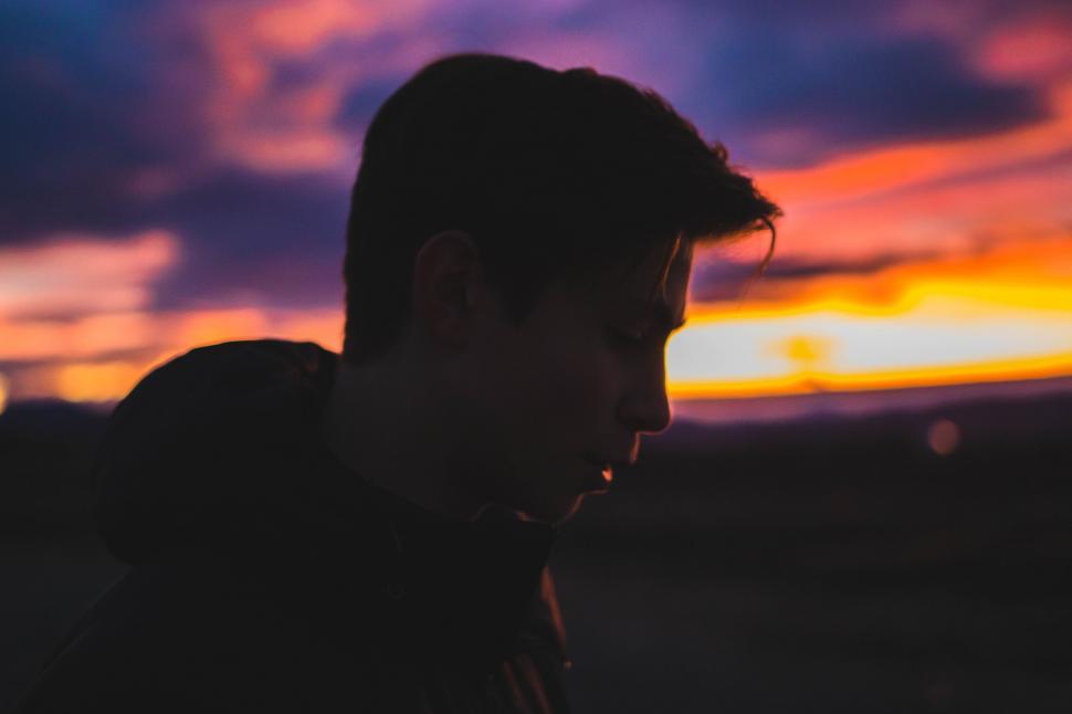 Free Image of Man Standing in Front of a Sunset 