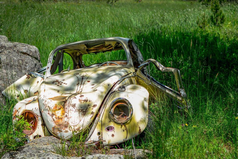 Free Image of Abandoned Rusty Car in Grass Field 