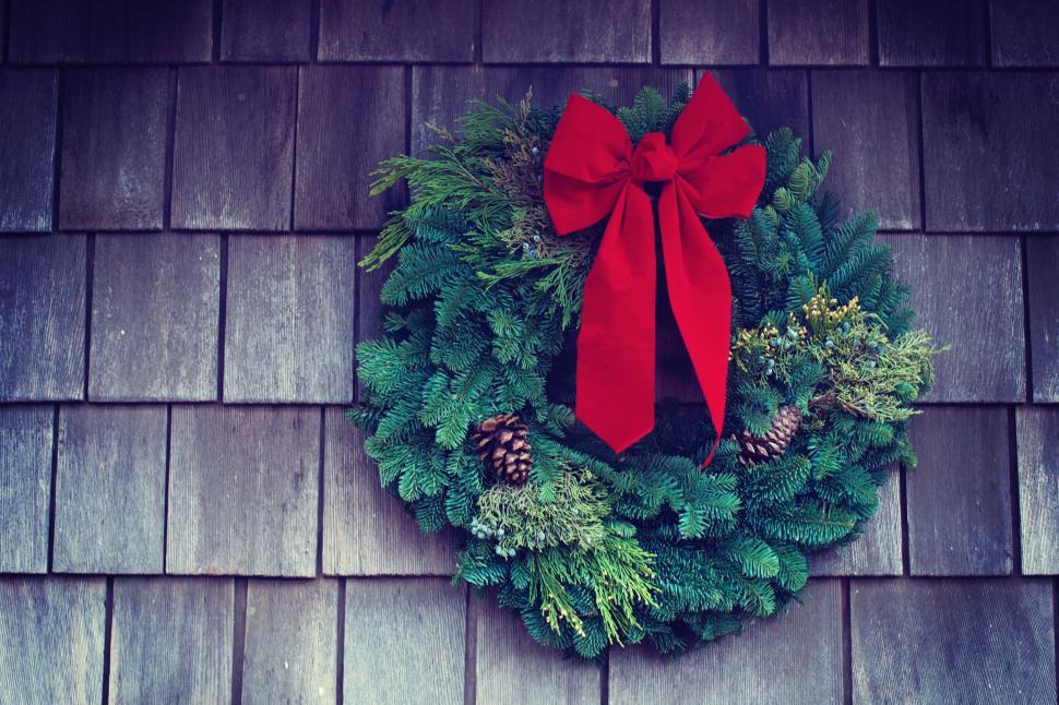 Free Image of Red Bow Wreath Hanging on Building 