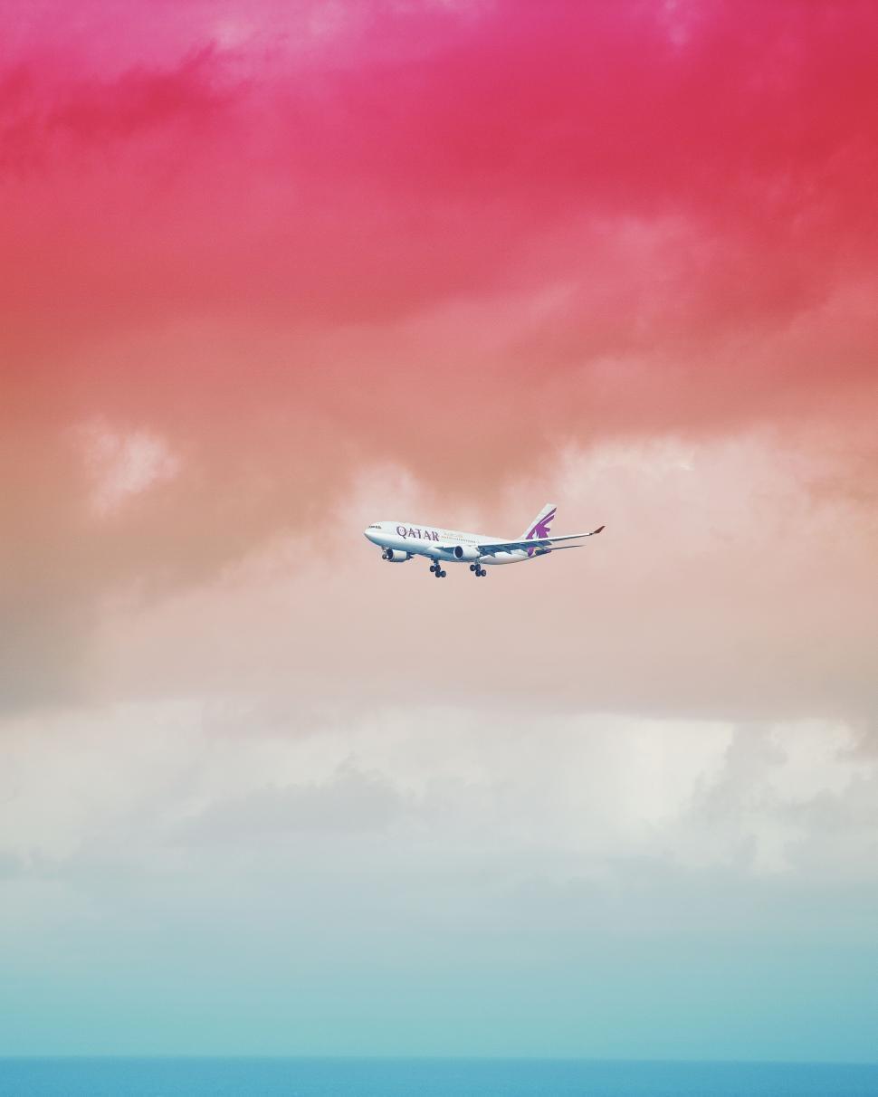 Free Image of Airplane Soaring in Pink and Blue Sky 