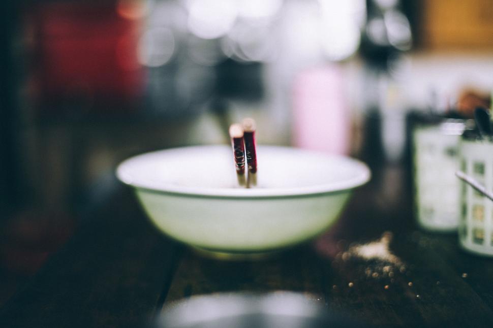 Free Image of Two Toothbrushes in a White Bowl on a Table 