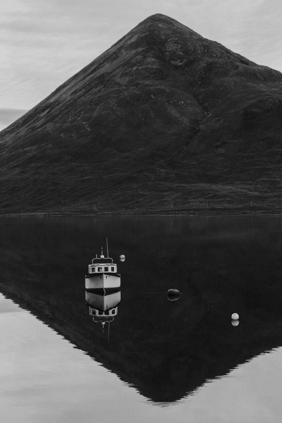 Free Image of Boat Floating on Lake Near Mountain 