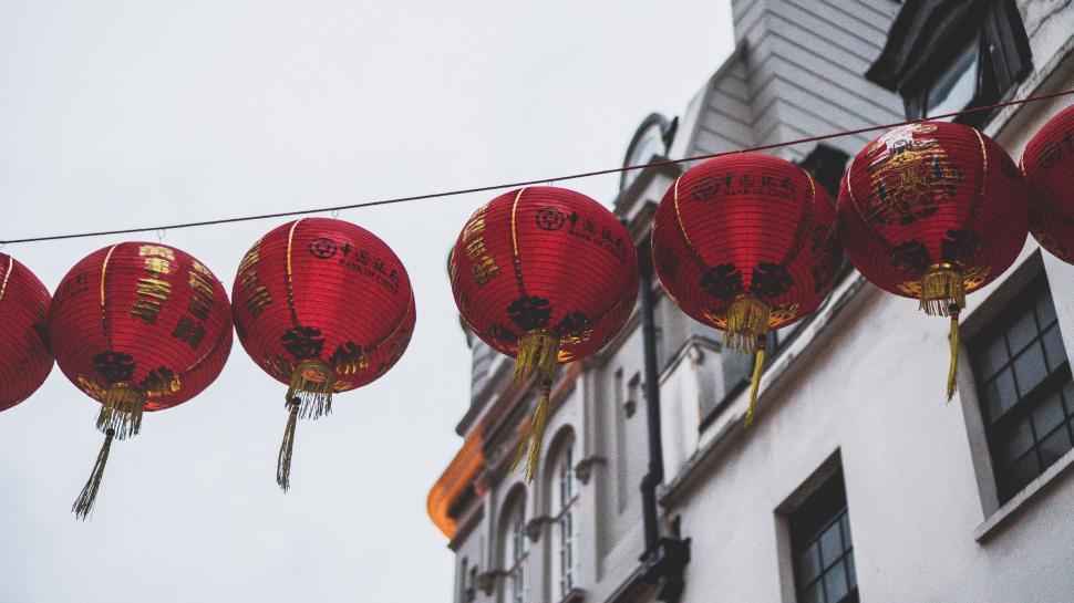 Free Image of String of Red Lanterns Hanging From a Building 