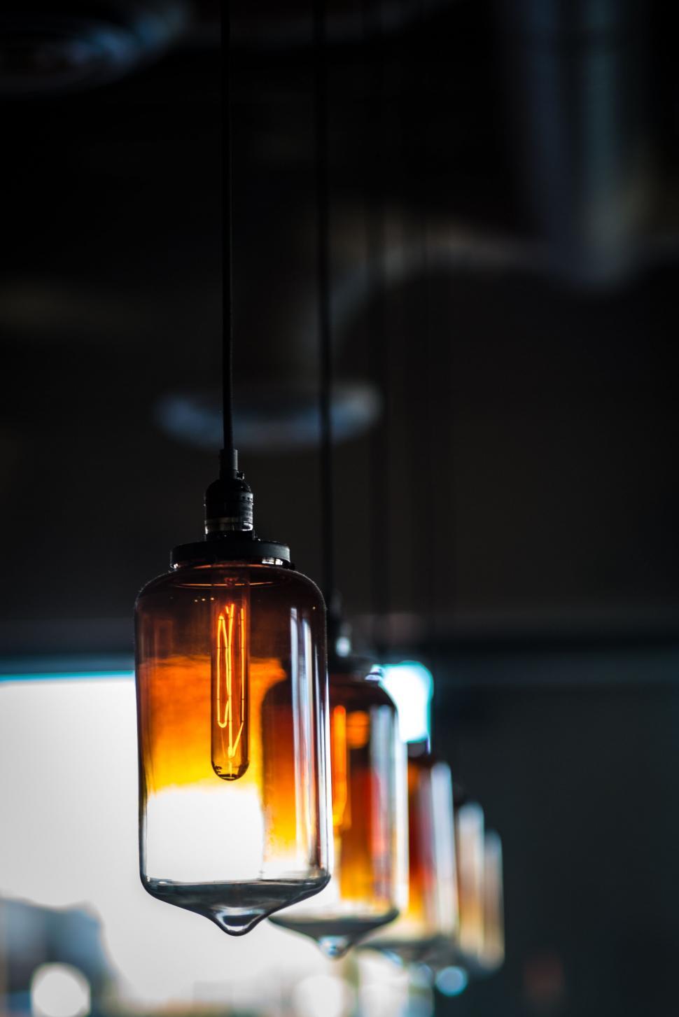 Free Image of Group of Glass Jars Hanging From Ceiling 