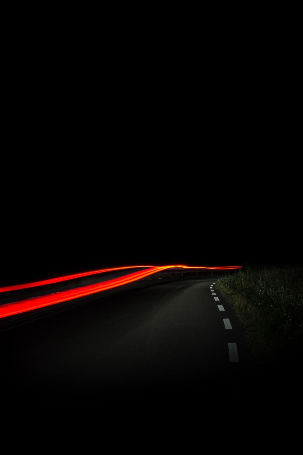 Free Image of Car Driving Down Dark Road at Night 