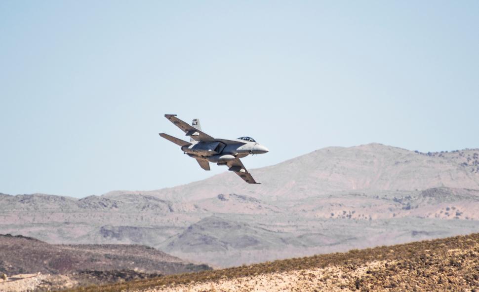 Free Image of Fighter Jet Soaring Above Mountain Range 