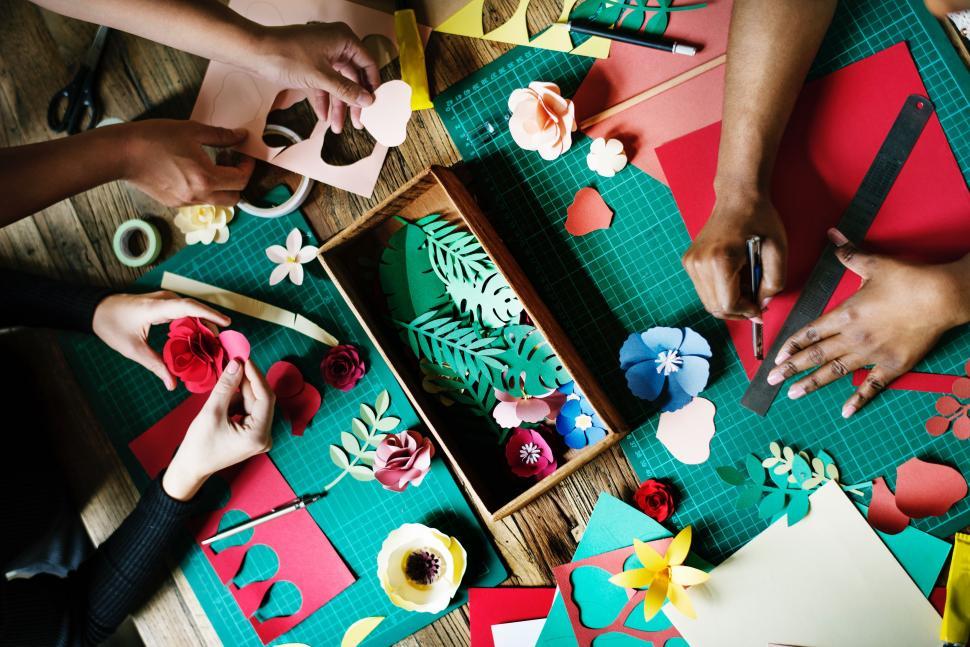Free Image of Group of People Making Paper Flowers on a Table 