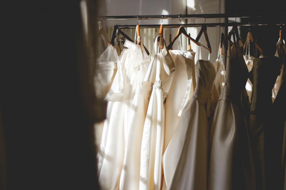 Free Image of Wedding Dresses Hanging in a Window 