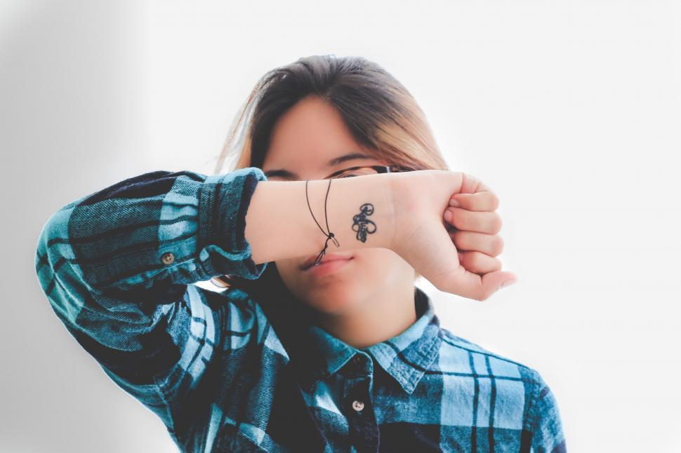 Free Image of Woman With Tattoo Covering Face 