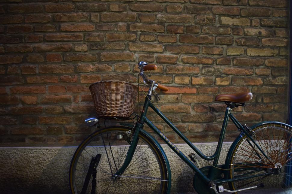 Free Image of Bicycle Parked Next to Brick Wall 