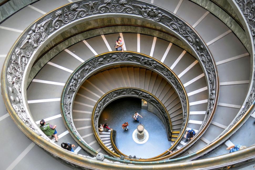 Free Image of People Walking Down Spiral Staircase 