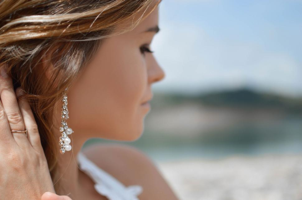 Free Image of Woman in White Dress Listening 