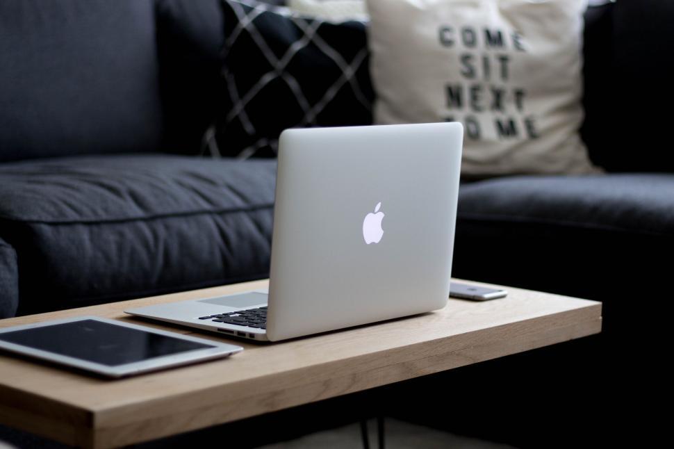 Free Image of Apple Laptop on Wooden Table 