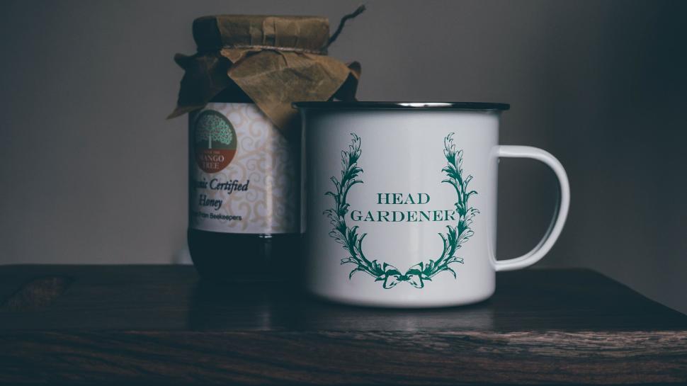 Free Image of White Coffee Mug and Can of Head Gardener 