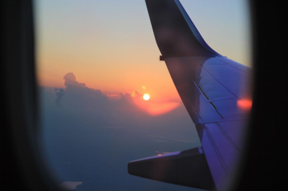 Free Image of Wing of Airplane Silhouetted Against Sunset 