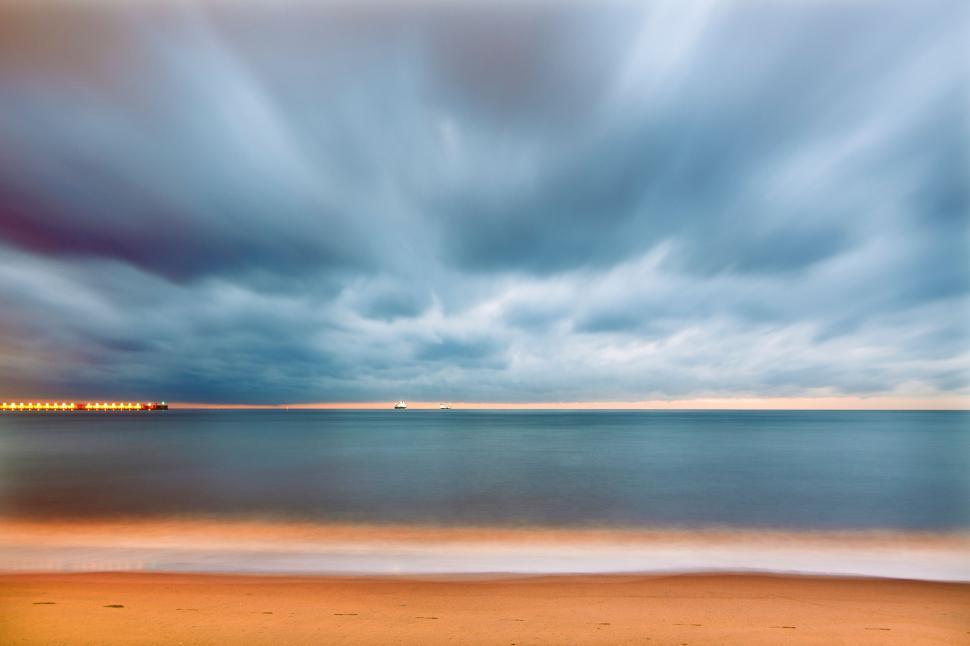 Free Image of Cloudy Sky Over a Beach 