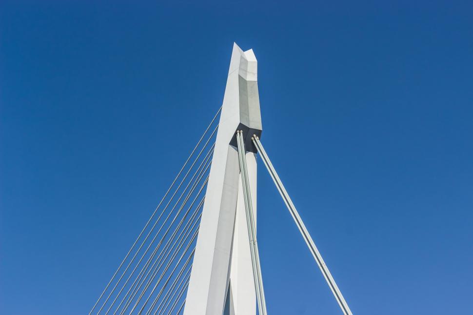 Free Image of Tall White Bridge Against Blue Sky 