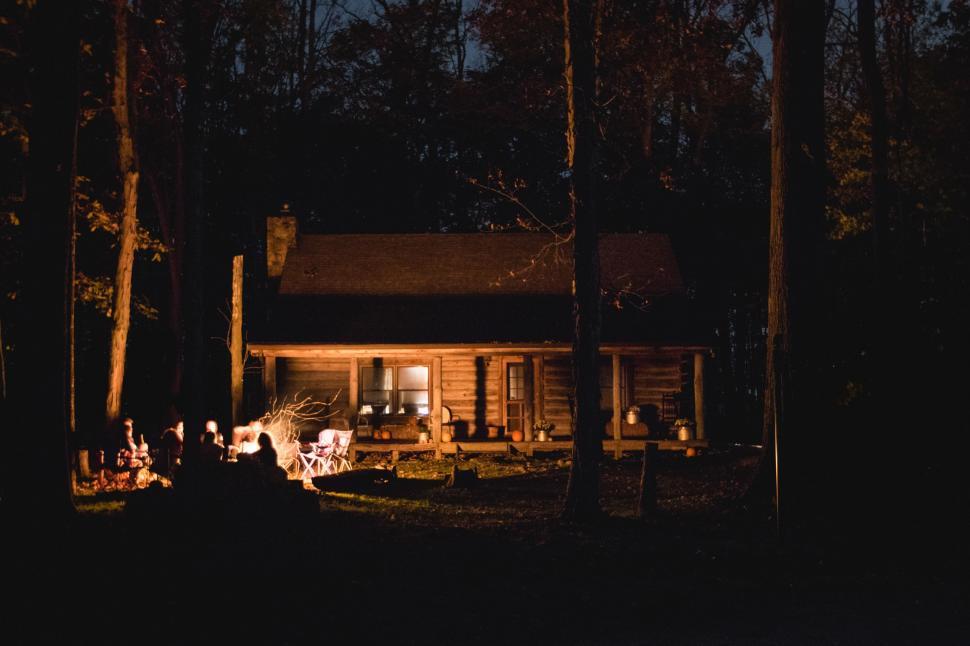 Free Image of A Cabin in the Woods Illuminated at Night 