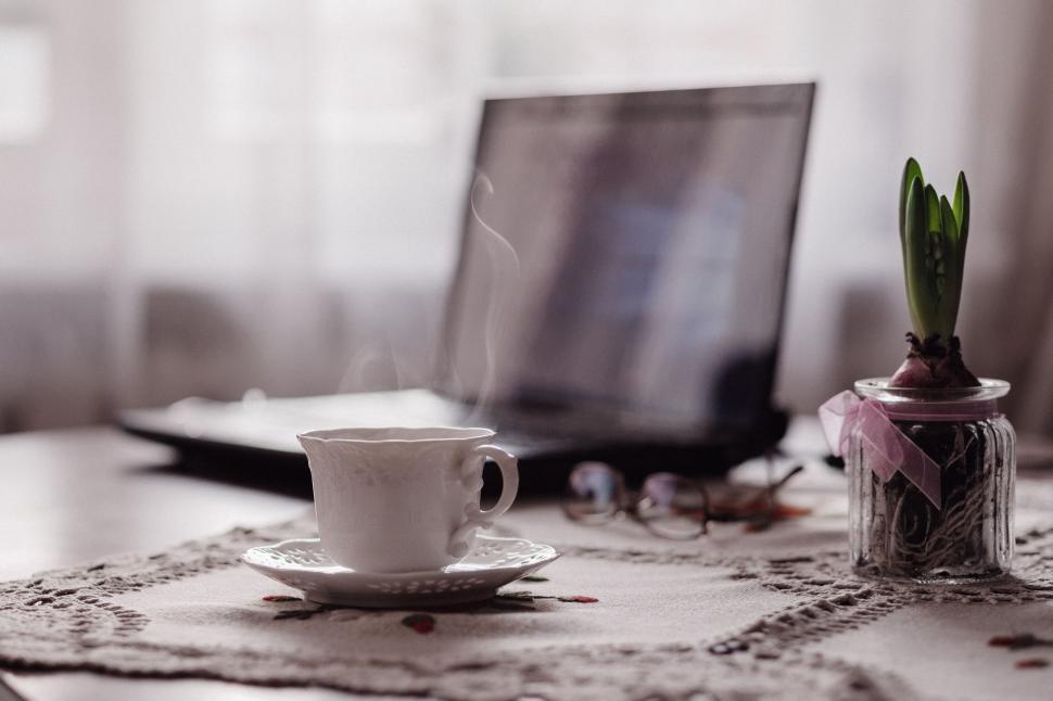 Free Image of Coffee Cup and Laptop on Table 