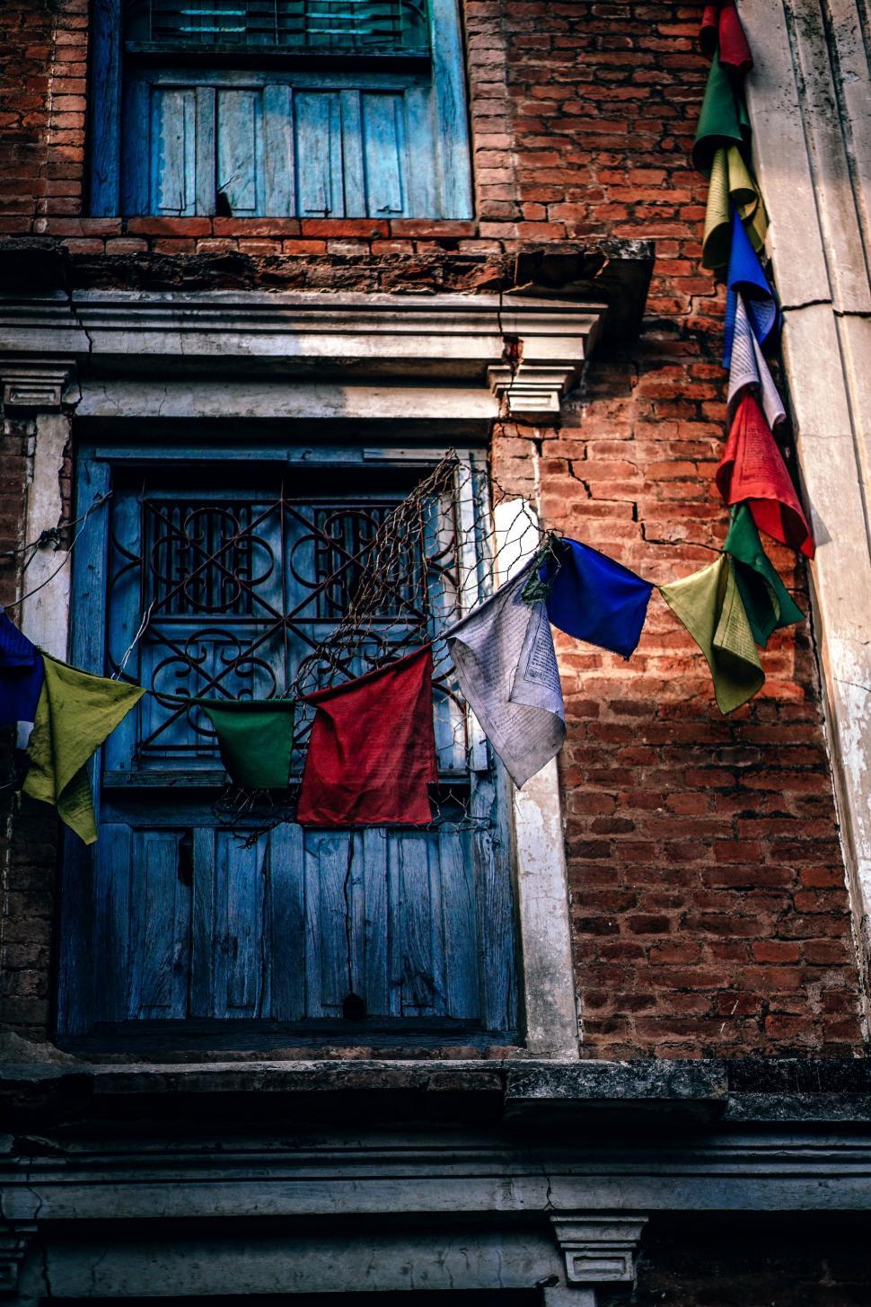Free Image of Colorful Flags Adorning Building Facade 