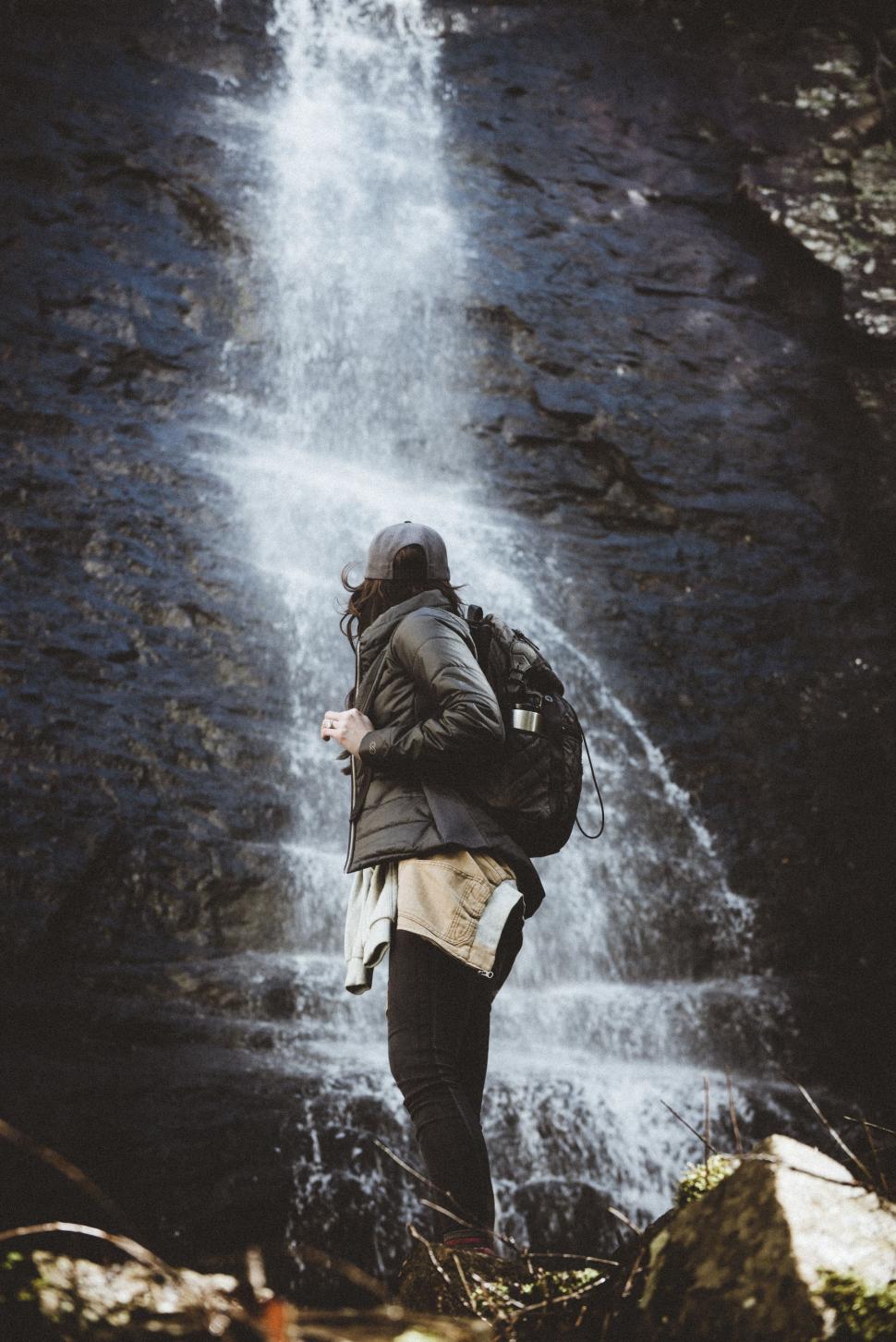 Free Image of Person Standing in Front of Waterfall 