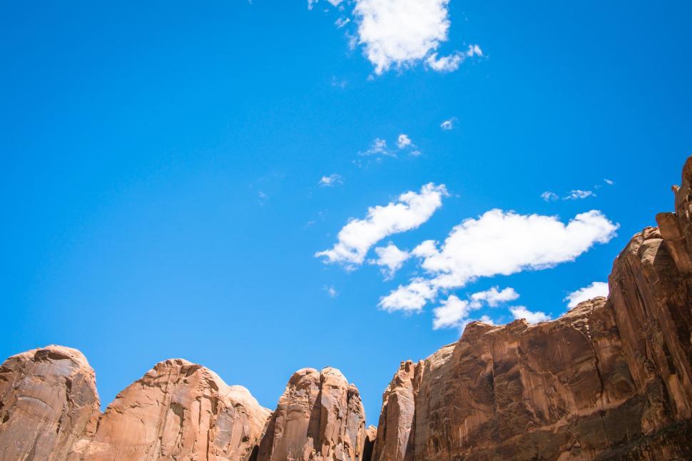 Free Image of Blue Sky With Clouds Above Rocks 