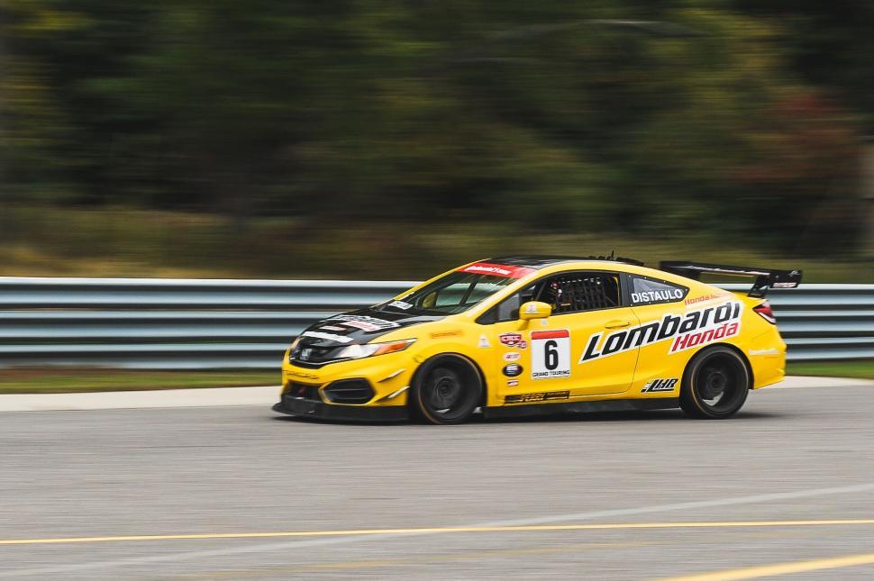 Free Image of Yellow Car Racing Through Track 