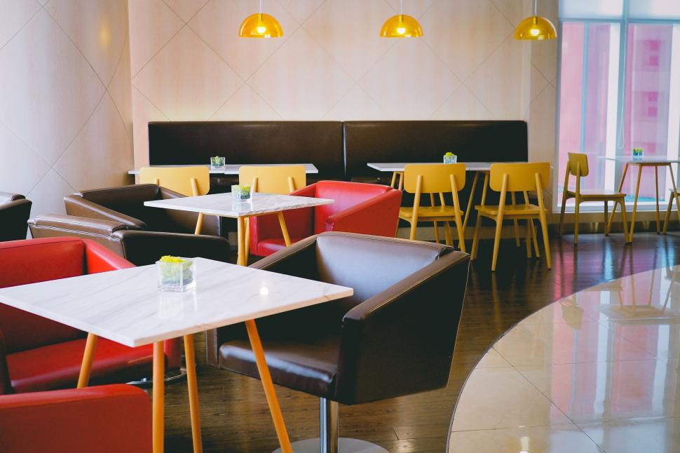 Free Image of Yellow and Red Chairs and Tables in Restaurant 