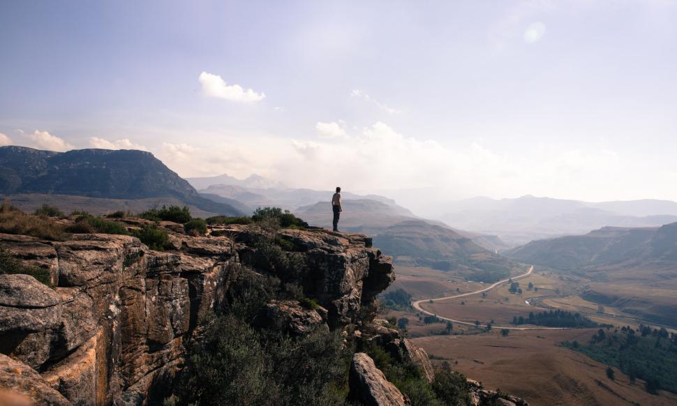 Free Image of Man Standing on Cliff Overlooking Valley 
