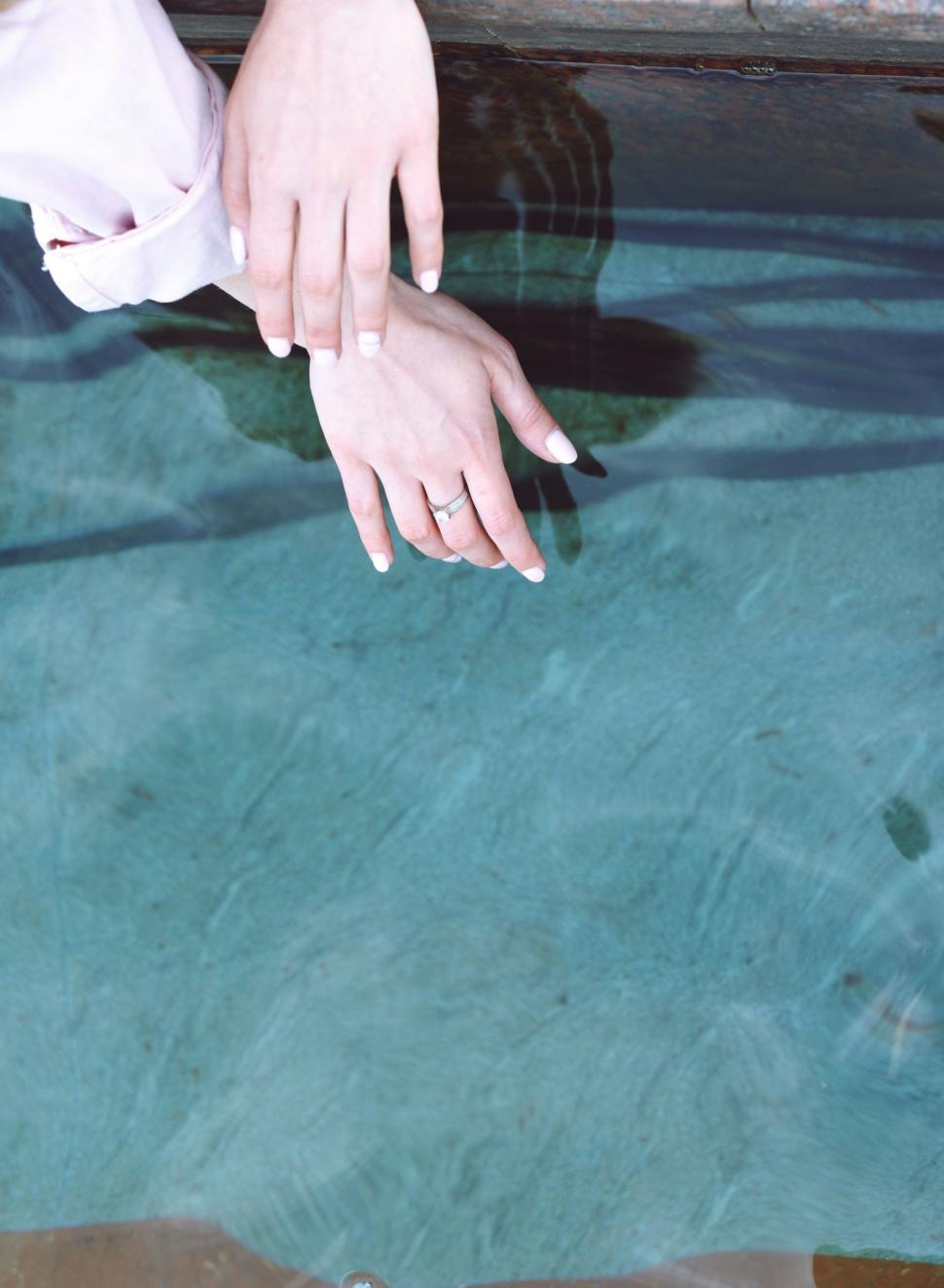 Free Image of Hand Reaching Into Pool of Water 