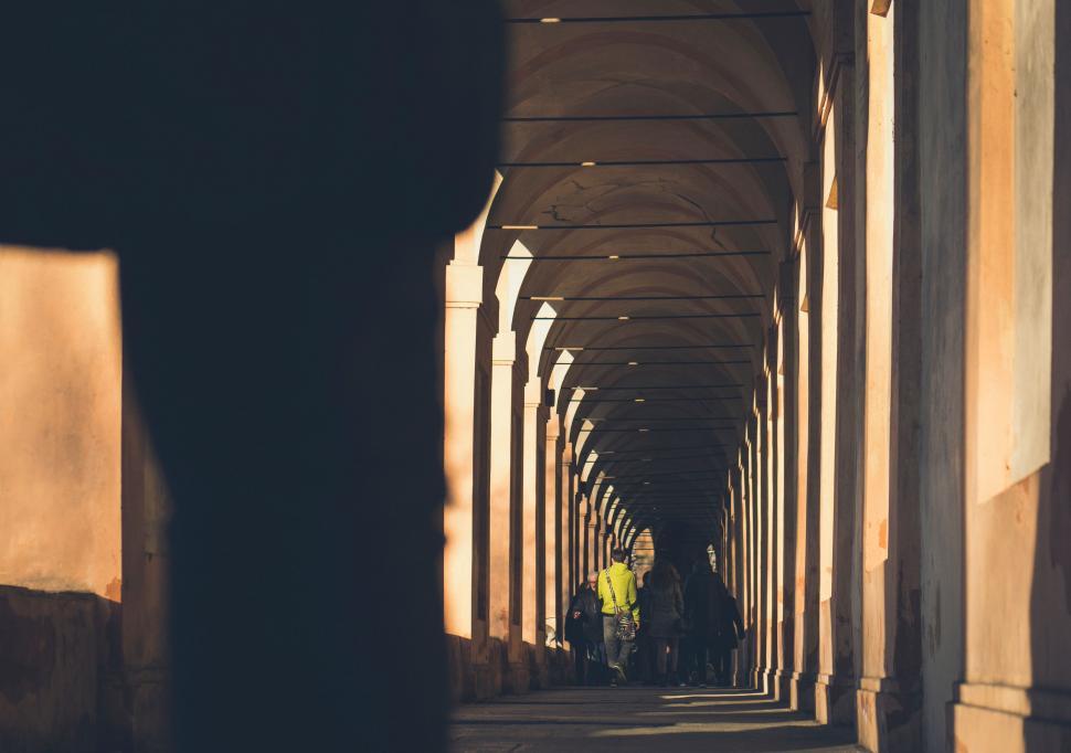 Free Image of Group of People Walking Down a Long Hallway 
