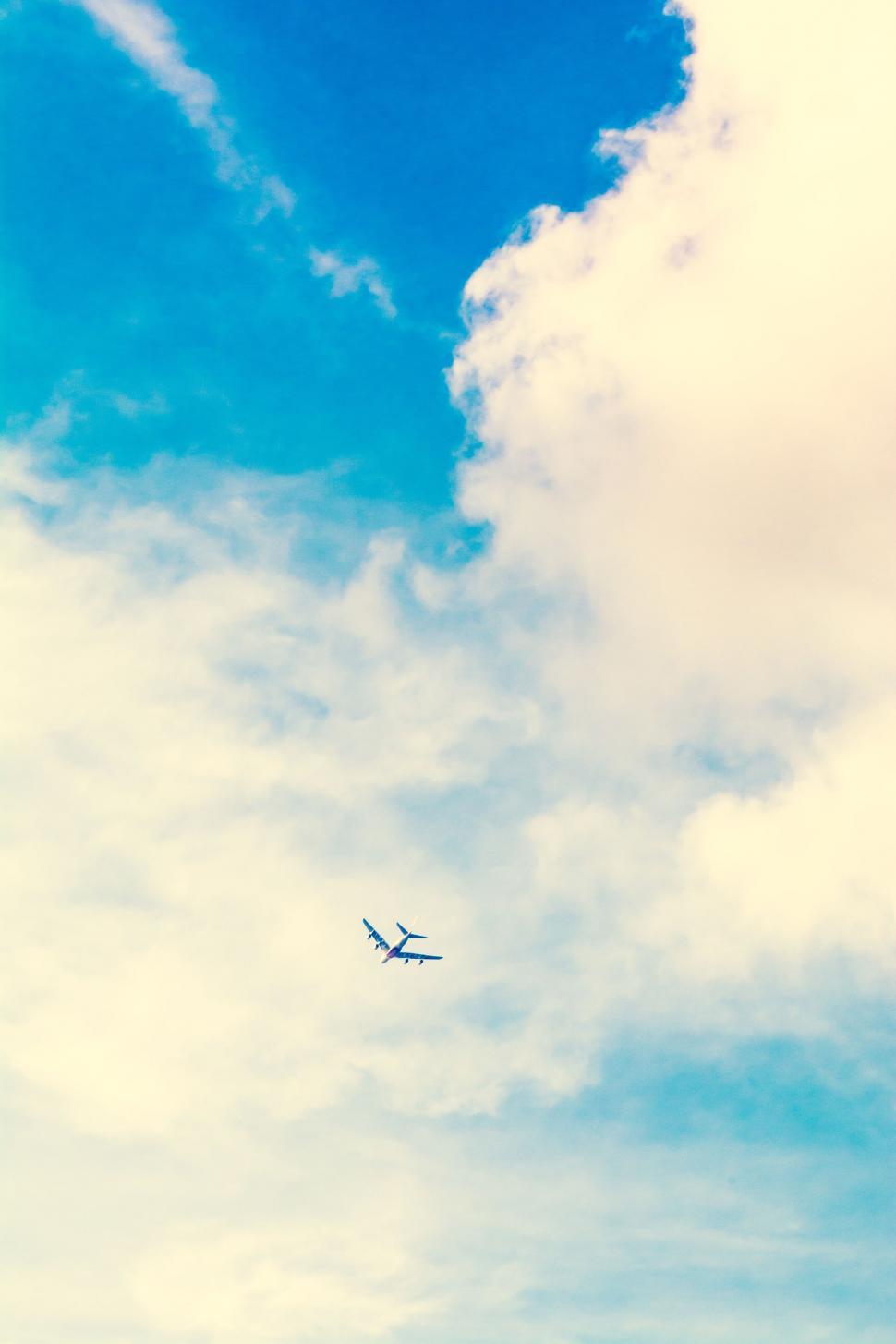Free Image of Airplane Flying Through Blue Sky 