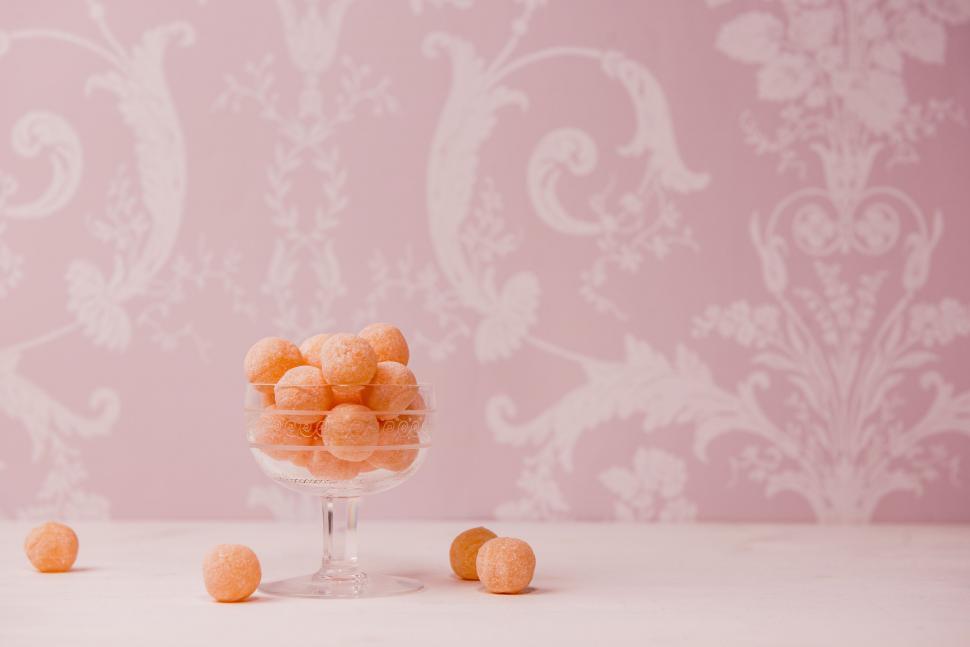 Free Image of Glass Filled With Orange Candies on Table 